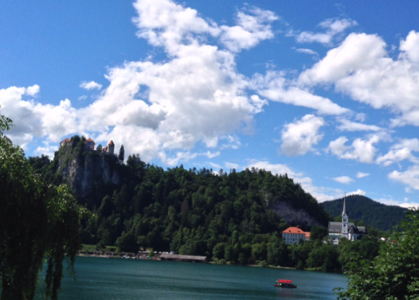 Een blik op het meer van Bled met links het Kasteel gelegen op een steile rotsheuvel & rechts de Sint-Martinuskerk